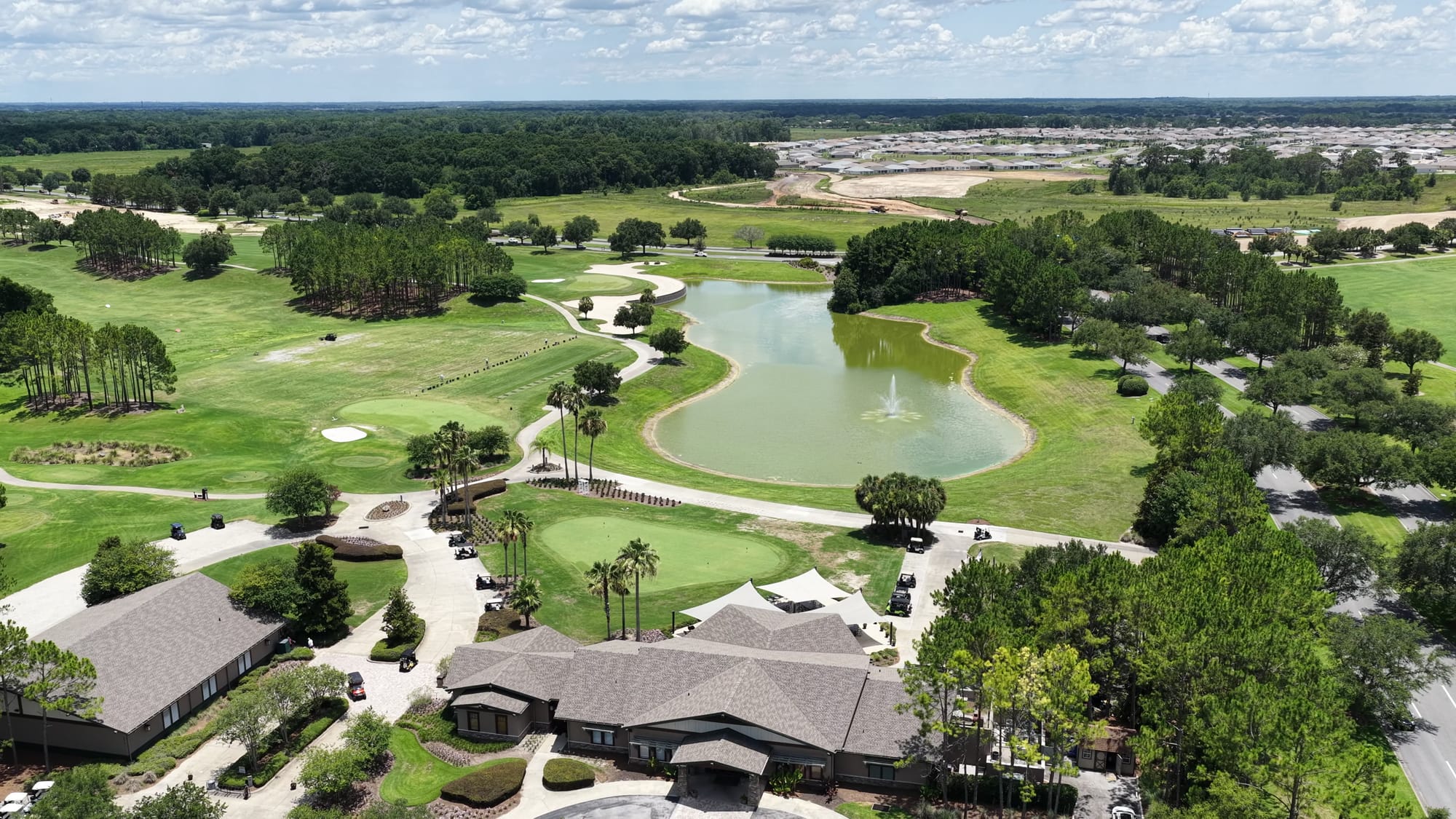 Del Webb Stone Creek clubhouse - High aerial drone shot showcasing the golf course 